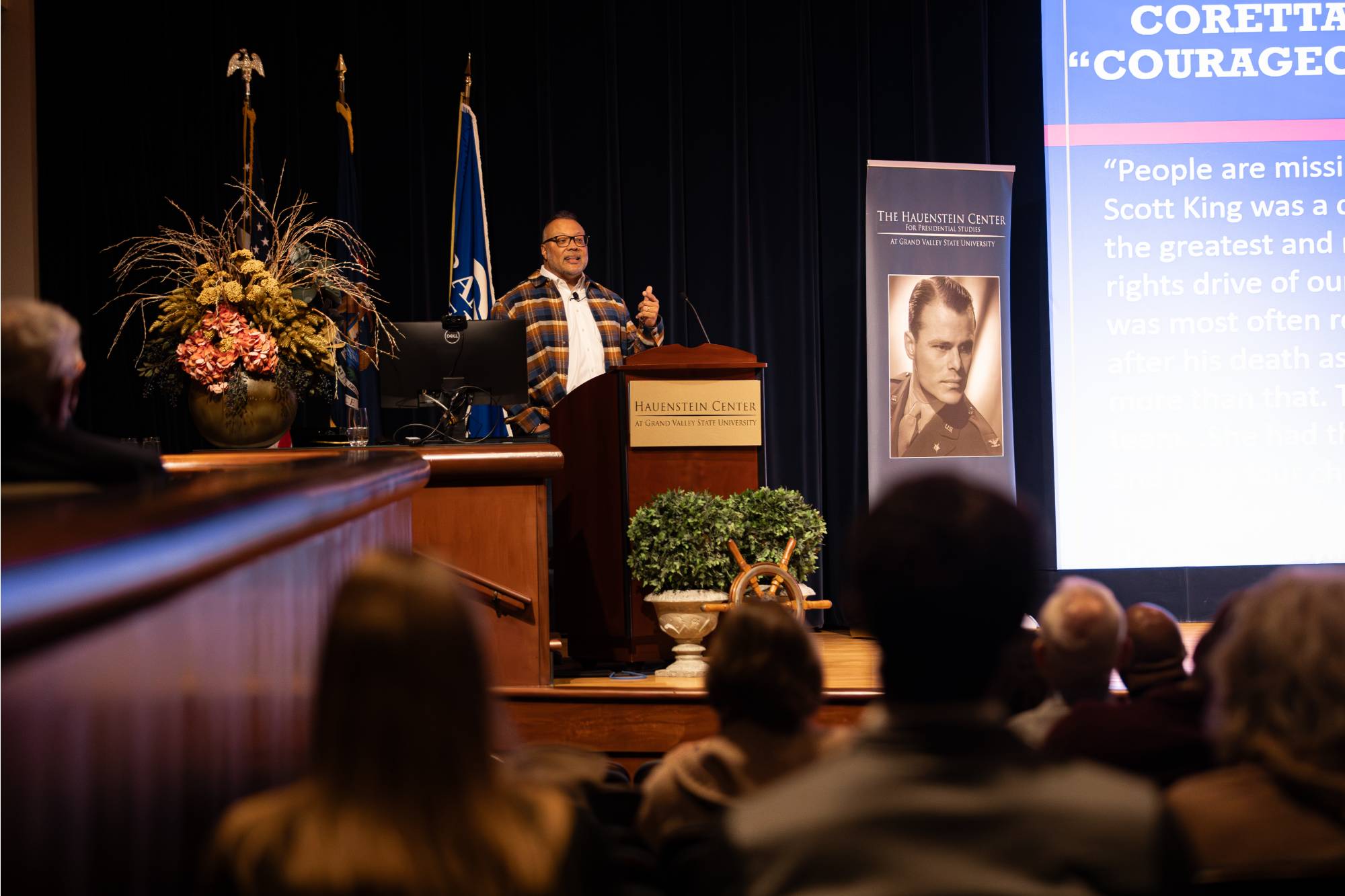 person speaking at a podium